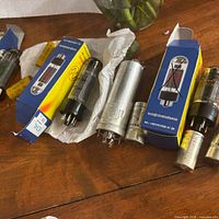 Assortment of tubes on table showing boxes, metal tubes and loose tubes