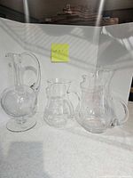 All three clear crystal pitchers side by side