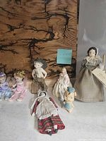 Group shot of all seven dolls and figurines