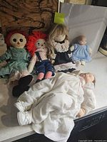 Group shot of all five dolls on countertop