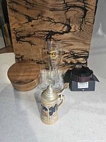 All six items together: wooden jewelry box, belt with box, beer stein, Hard Rock schooner, two shot glasses