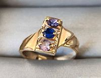 Front view showing three colored stones and gold setting