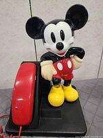 Front view of Mickey Mouse phone showing handset and figurine