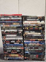 Three vertical stacks of DVD movies, full lot overview