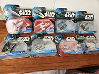 All eight sealed Hot Wheels Star Wars Starships displayed front of cards