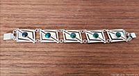 Full view of sterling silver bracelet showing five malachite-set links