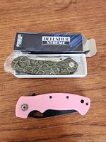 Both knives: Defender Xtreme in box and pink handle knife