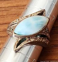 Top view of sterling silver ring with blue pectolite stone on ring mandrel