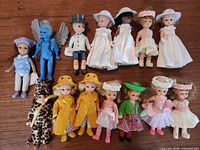 Group shot of all 13 dolls laid out on table