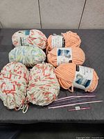 Six skeins Bernat yarn and knitting tools overview