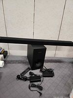Sound bar, subwoofer, remote, two power adapters, audio cable overview