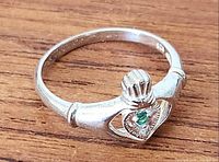Top view of Claddagh ring showing crown, hands, heart and green stone