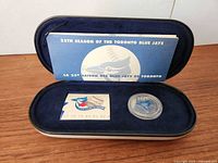 Full set in presentation case showing booklet, stamp, medallion