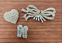 Group shot showing pendant, brooch, pair of earrings