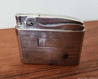 Front and side view of sterling silver Ronson lighter showing overall design and wear