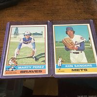 Front view of both baseball cards in sleeves (Marty Perez, Ken Sanders)