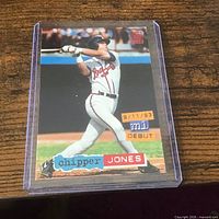 Front view of card in sleeve showing action photo and graphics