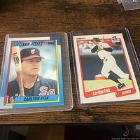 Two Carlton Fisk cards in sleeves, Topps left, Fleer right