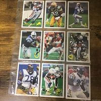 Fronts of nine football cards in binder page