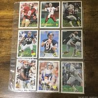 Front view of nine football cards in sheet
