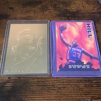 Fronts of both Grant Hill cards: metallic embossed portrait and color action card