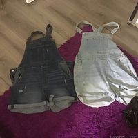Both denim shortalls side by side on floor