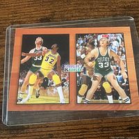 Front of card showing both action images and Magic & Bird title