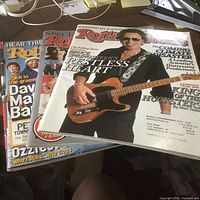 Stack of four Rolling Stone magazines showing assorted covers