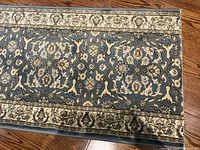 Close view of pattern and border on one runner