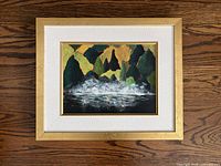 Front view of framed landscape painting in gold frame and white mat