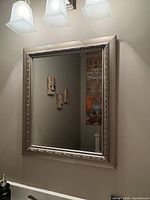 Full view of framed mirror mounted on wall