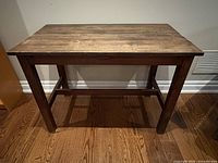front view of walnut finish desk showing top and legs