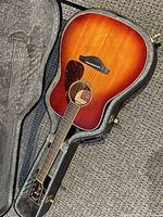 Full view of Yamaha FG740SFM guitar inside case showing sunburst finish and overall condition