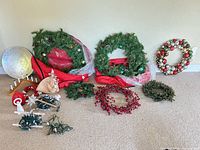 Group shot showing wreaths, lights, hat, lantern