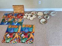 overview showing wooden tray, placemats, plates, shell dishes and bowl