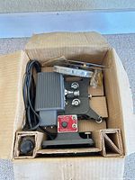 Projector, spare bulb, reel, all packed in original box