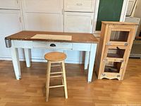 Front view of work table, stool and pine cabinet