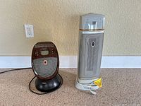 Tower and personal heaters side by side cords visible