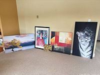 All five art pieces standing against wall