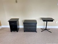 Front view of all three black furniture pieces