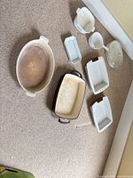 Group shot of all eight baking pieces arranged on carpet