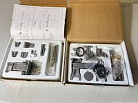 Two boxed milling/lathe parts kits with components in trays and schematic sheets
