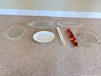 Seven serving pieces laid out on carpet