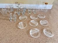 Full lot layout showing plates, stemware, decanters, vase, small vessel
