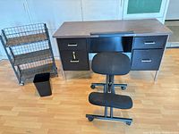 Desk, chair, wire cart, waste bin group view