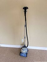 Full view of assembled Titan garment steamer showing base, hose, wand and steam head