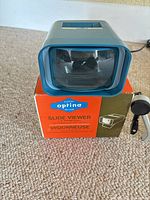 Blue Eaton Optina De Luxe slide viewer on its box