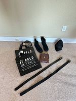 Lot overview showing boots, brown pouch, tote bags, belts, wedge shoe
