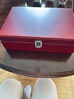 Closed red wooden display box with latch