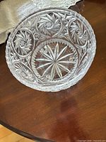 Interior view of cut glass bowl showing starburst pattern and side cuts